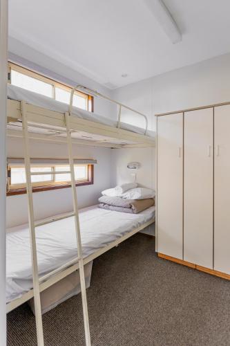 a bedroom with two bunk beds and a closet at Ocean Grove Holiday Park in Ocean Grove