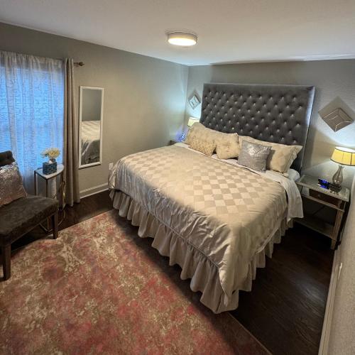 a bedroom with a large bed and a chair at Cozy Single-family house in Glendale