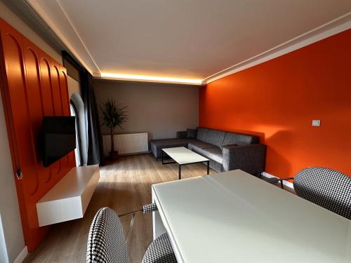 a living room with a couch and a table and chairs at OTTO Tunalı Houses in Ankara