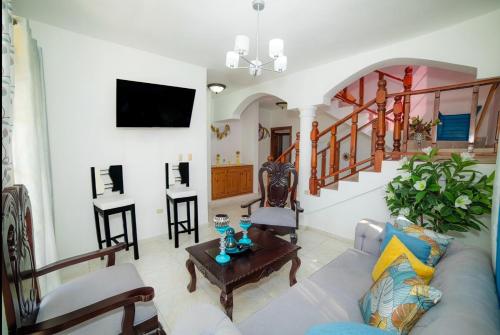 a living room with a couch and a table at Spacious and secure villa in Puerto Plata