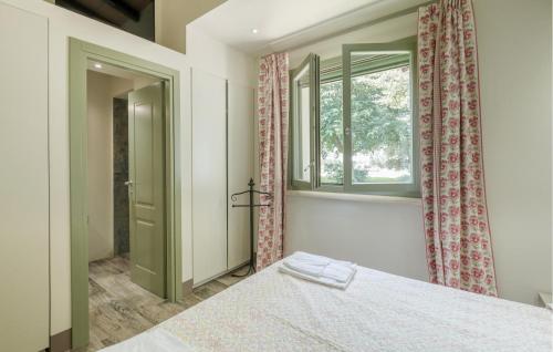 a bedroom with a bed and a window at Nice Home In Montalto Di Castro in Montalto di Castro