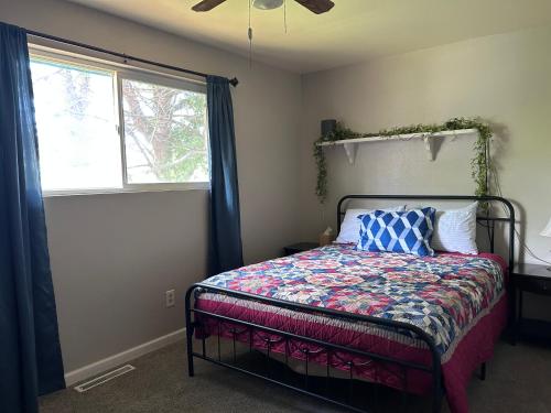 a bedroom with a bed and a window at Sunny Days in Pocatello