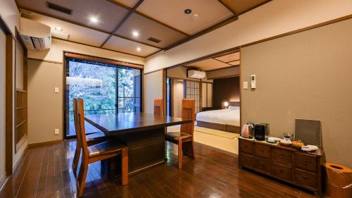 a room with a desk and a bed and a bedroom at Kaze no Tani no Iori in Gamagori