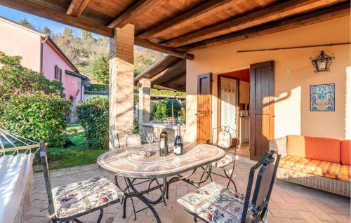 a patio with a table and chairs and a couch at Amazing Home In San Giovanni in Montefiore dellʼAso