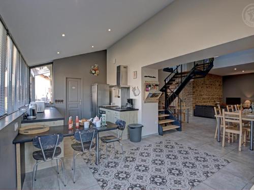 - une cuisine et une salle à manger avec un escalier dans une maison dans l'établissement Gîte Familial 200m² avec Jardin, Terrasse, Jeux, et Confort Moderne à Chazelles-sur-Lyon - FR-1-496-203, à Chazelles-sur-Lyon