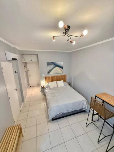 a bedroom with a bed and a table in it at Blue Ocean in Mar del Plata