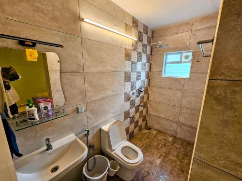a bathroom with a toilet and a sink at Garden Villa, Tranquil 2BR Retreat, Pool & Garden, Mahabalipuram in Mahabalipuram