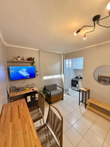 a living room with a table and a tv at Blue Ocean in Mar del Plata