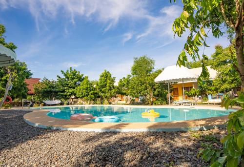 a swimming pool at a resort at Ana-as Apartelle (GGL) in Panglao