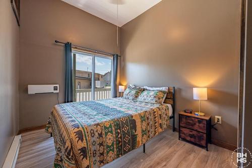 a small bedroom with a bed and a window at Downhill Lodge Condominium in Lake Placid