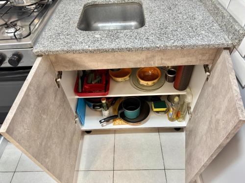 a kitchen counter with a sink and some utensils at Blue Ocean in Mar del Plata