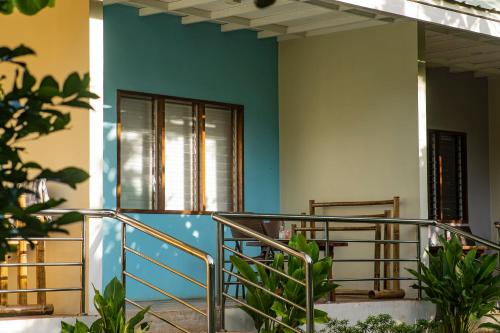 a building with a blue wall and stairs at Ana-as Apartelle (GGL) in Panglao