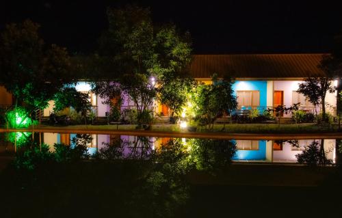a building at night with its reflection in the water at Ana-as Apartelle (GGL) in Panglao