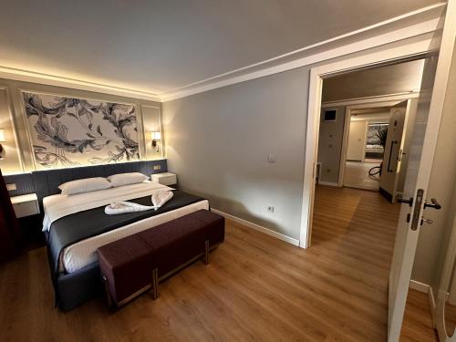 a bedroom with a bed and a large painting on the wall at OTTO Tunalı Houses in Ankara
