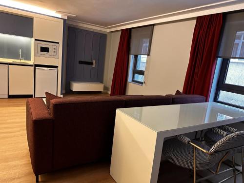 a living room with a couch and a table at OTTO Tunalı Houses in Ankara