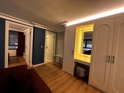 a living room with a sink and a mirror at OTTO Tunalı Houses in Ankara