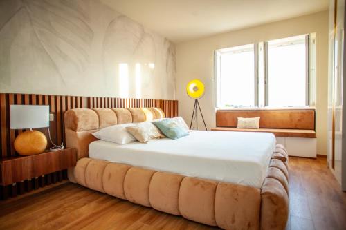 a bedroom with a large bed with a large ottoman at Portunata Penthouse - Novalja Center in Novalja
