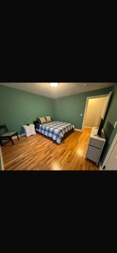 a bedroom with a bed in the corner of a room at Elegant 3BR Home in Worcester in Worcester
