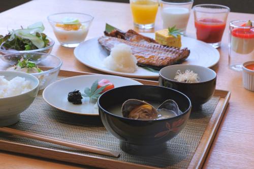 a table with plates of food and bowls of food at Okujozankei Onsen Kasho Gyoen in Jozankei