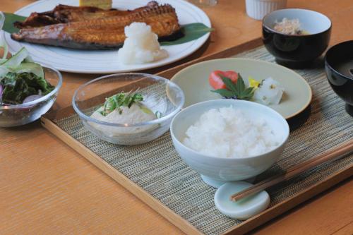 a table with plates of food and bowls of rice at Okujozankei Onsen Kasho Gyoen in Jozankei