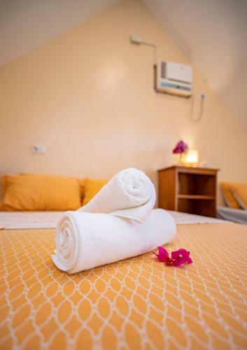a towel sitting on top of a bed at Ana-as Apartelle (GGL) in Panglao