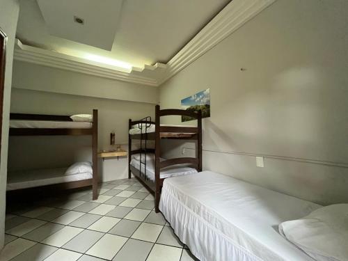 a bedroom with two bunk beds in a room at Casa Piauí Hostel in Teresina