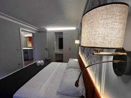 a bedroom with a bed with a lamp on it at OTTO Tunalı Houses in Ankara