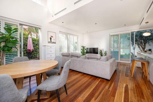 a living room with a couch and a table at Beachfront Hampton in Melbourne