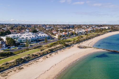 an aerial view of a beach and buildings at Beachfront Hampton in Melbourne