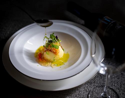 a plate of food with a spoon on a table at Okujozankei Onsen Kasho Gyoen in Jozankei
