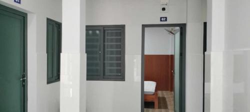a room with two doors and a mirror on the wall at Hoàng Yến Hotel Thanh Hoà in Cai Lậy