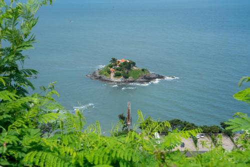 an island in the water with a house on it at KLY Hotel Vung Tau in Vung Tau