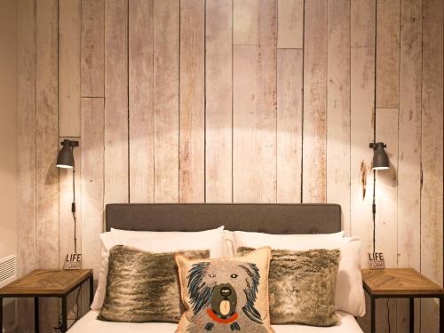 a bedroom with a bed with a wooden wall at Lancaster City Apartment in Lancaster