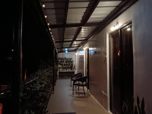 a hallway with a chair in a room with plants at Kua's Pad Tagaytay in Tagaytay