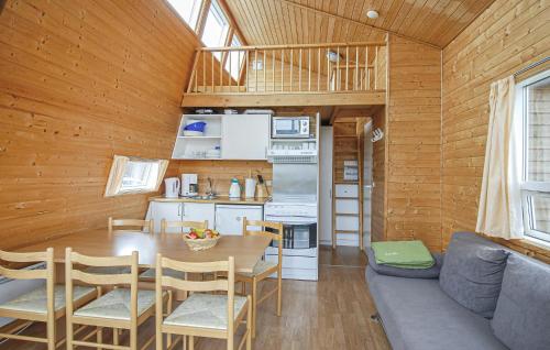 a kitchen and dining room of a tiny house at Holiday Home Hvide Sande 9 in Hvide Sande
