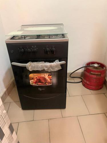 a black oven with a fire inside of it at Torobali IMMO Studio 1 -Cozy Furnished Studio - City Center Bamako- Ideal for short Stays in Bamako