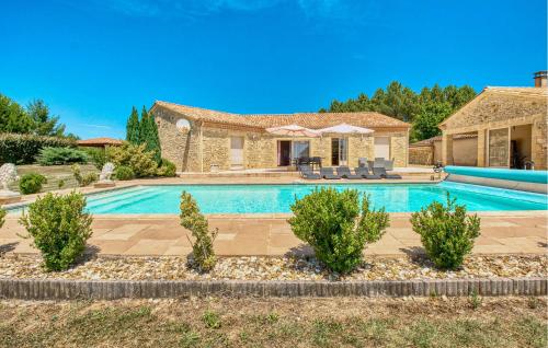 a villa with a swimming pool and a house at Charmante Maison Avec Piscine in La Douze