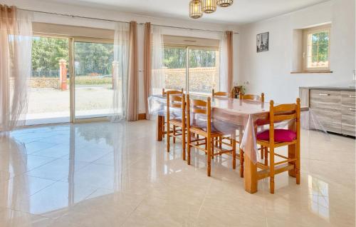 a kitchen and dining room with a table and chairs at Charmante Maison Avec Piscine in La Douze