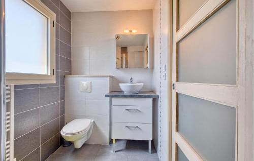 a small bathroom with a toilet and a sink at Charmante Maison Avec Piscine in La Douze