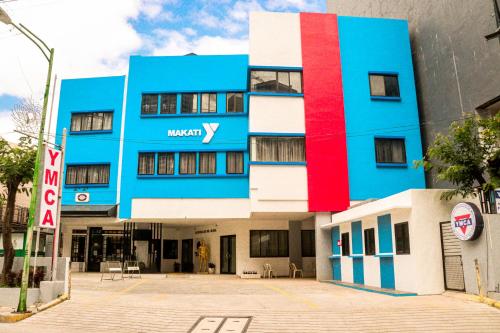 a blue building with a red stripe on it at YMCA Makati in Manila