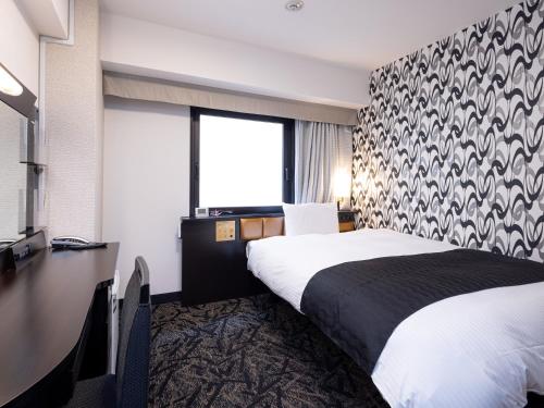 a hotel room with a bed and a large window at APA Hotel Nagoya Sakae Ekimae EXCELLENT in Nagoya