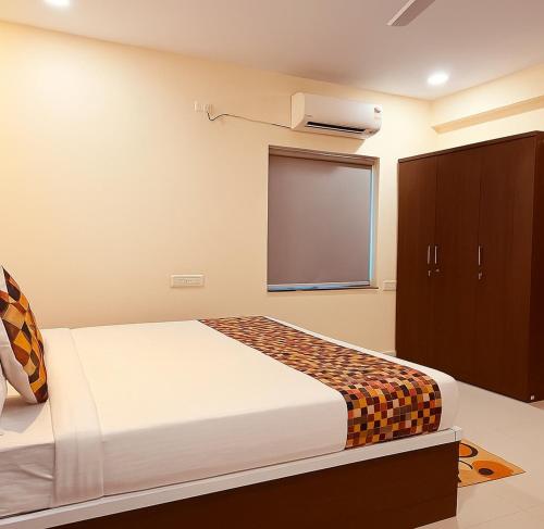 a bedroom with a bed and a projection screen at Hotel Urban Prime Near Hitech City in Hyderabad