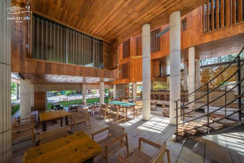 a building with a staircase and tables and chairs at Harvest Day Hoi An in Hoi An