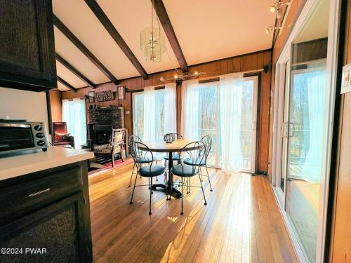 a kitchen with a table and chairs in a room at Paradise Uncovered Chalet Near Lake in Hawley