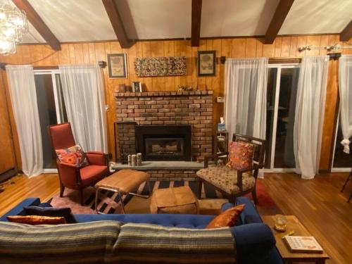 a living room with a couch and a fireplace at Paradise Uncovered Chalet Near Lake in Hawley