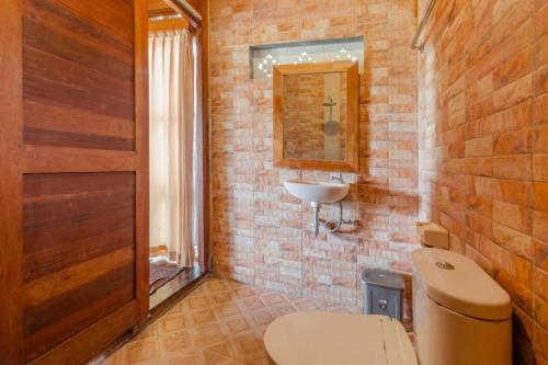 a bathroom with a toilet and a sink at Precious Journey Retreat in Ubud