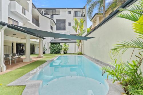 a swimming pool in the backyard of a building at Cairns City Apartments in Cairns