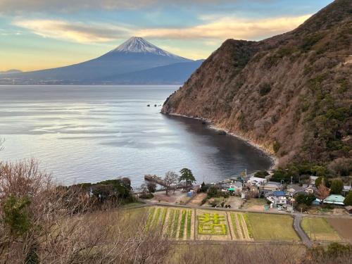 a view of a mountain over a body of water at 貸切宿 ひととき -Hitotoki- 眺めの良いテラスでBBQが楽しめる 徒歩で海と温泉へ 温泉券プレゼント 最大12名 in Numazu
