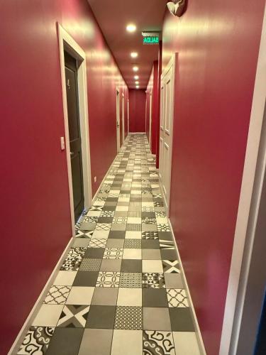 a hallway with a checkered floor and pink walls at Luxury Suite at Cumbaya Park in Quito