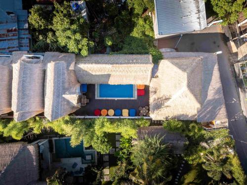 an overhead view of a house with a swimming pool at Tricky Trees Lodges in Gili Air